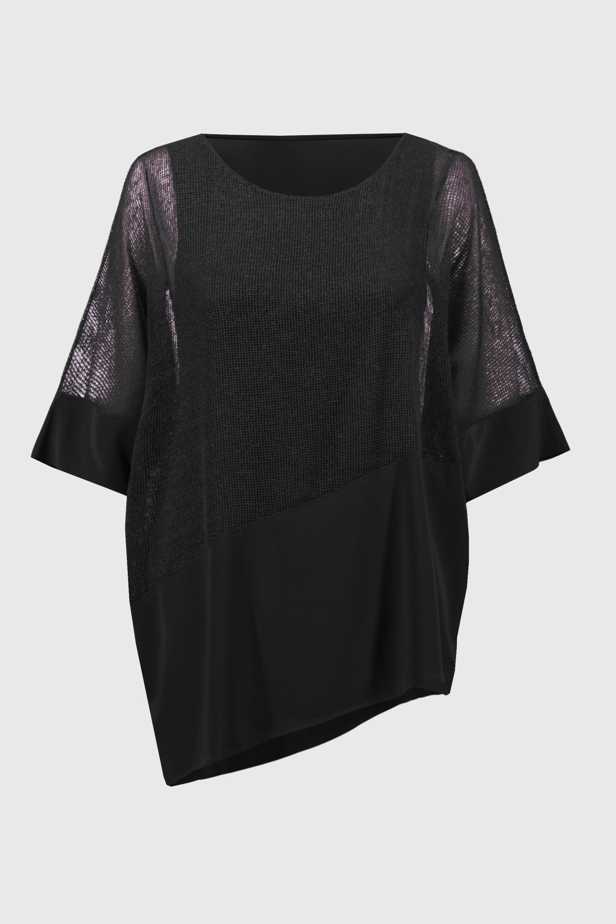 Studio flat lay of the black cocoon top, showing its asymmetrical hemline and mixed fabric textures.