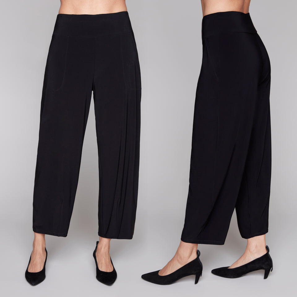 Black lantern pants worn by a person on a plain background
