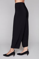 Black lantern pants side view worn by a person on a plain background