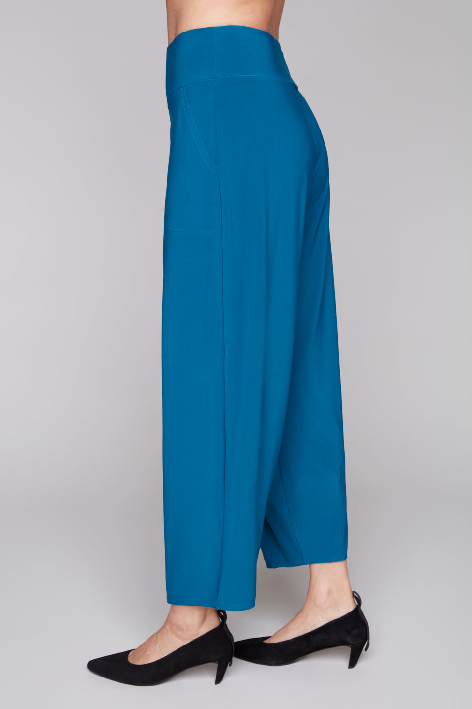 Blue lantern leg pants side view worn by a person on a plain background