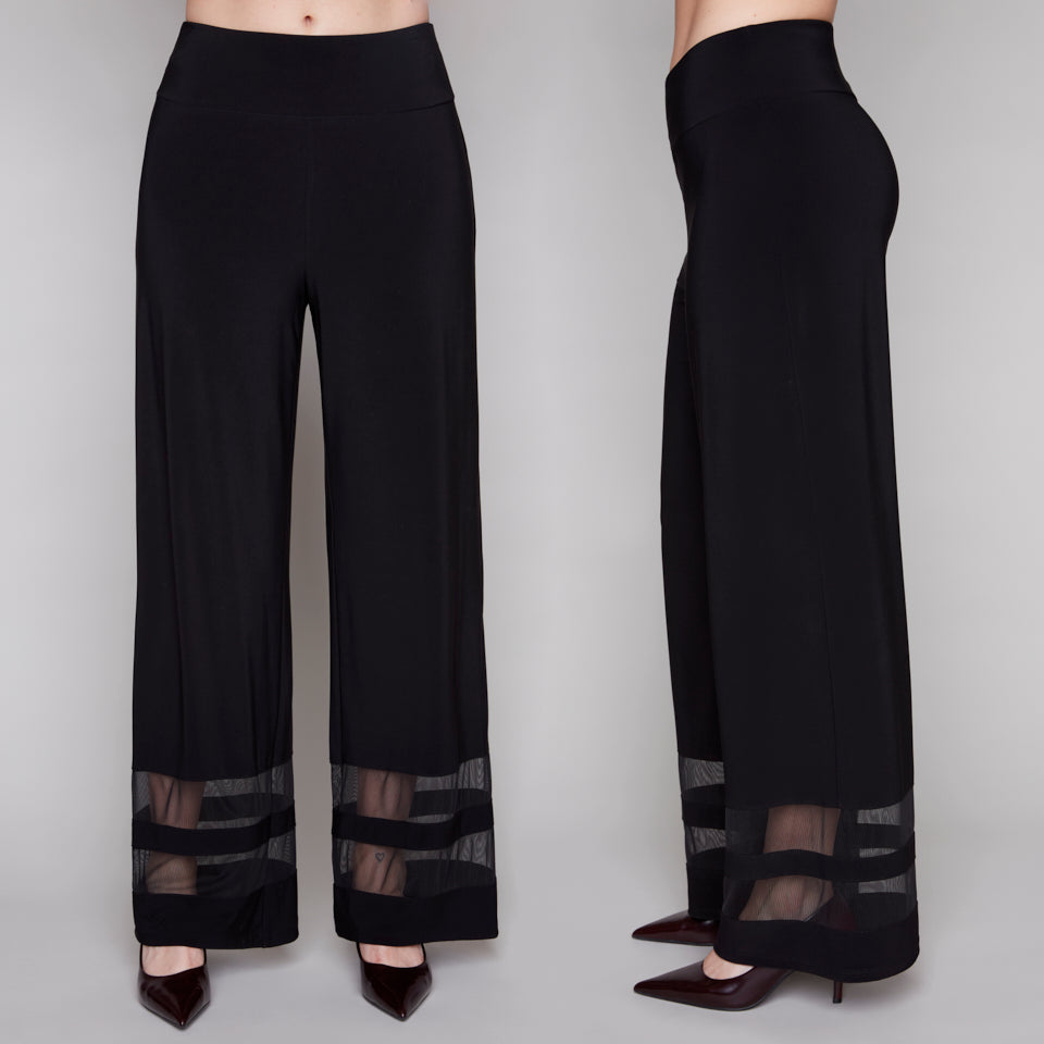 Black wide-leg pants with sheer mesh at the bottom on a gray background