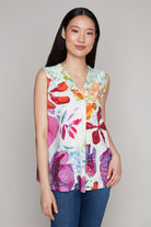 Woman in floral print sleeveless V-neck top and blue jeans