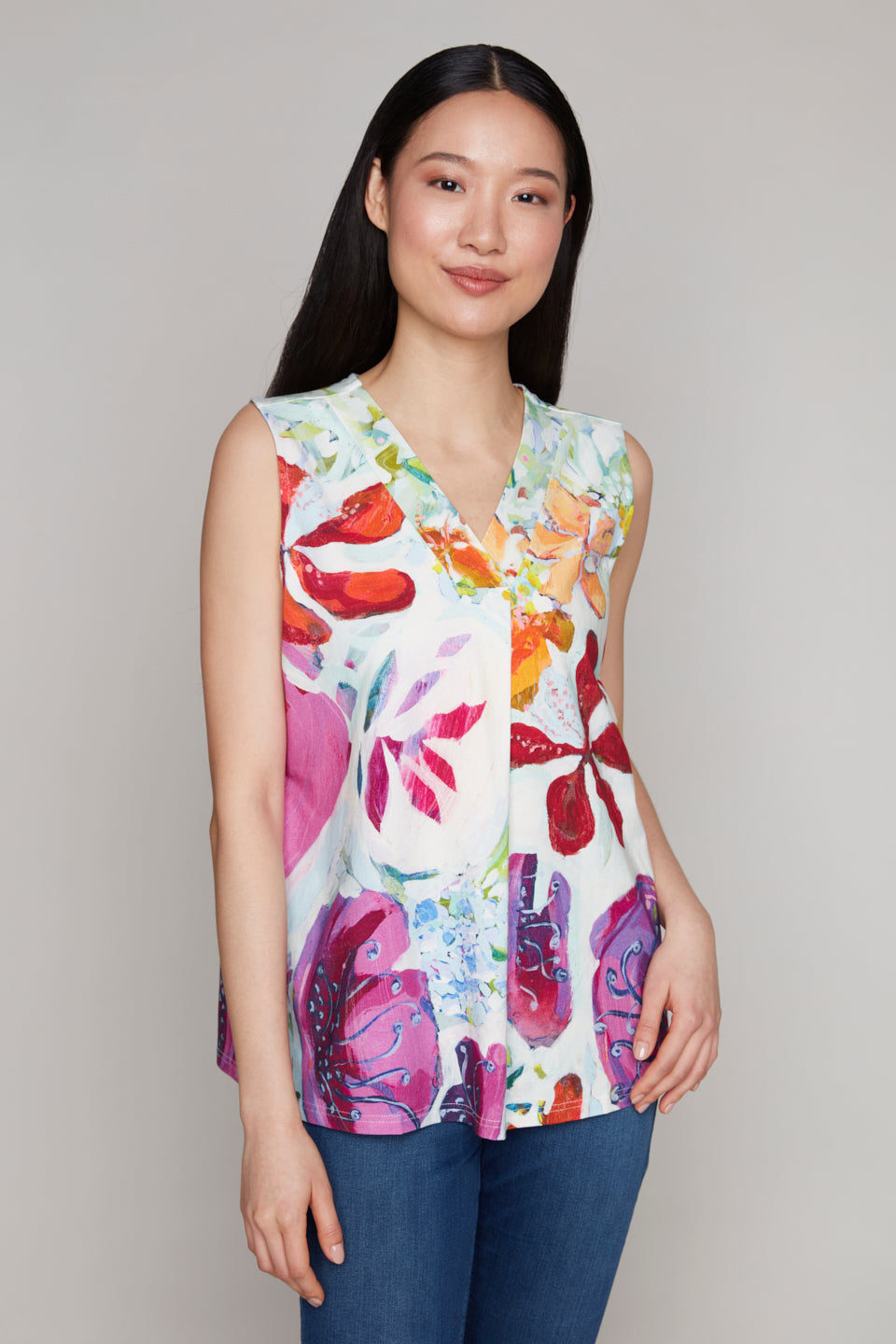 Woman in floral print sleeveless V-neck top and blue jeans
