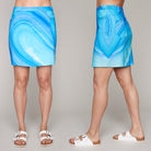 Front and side view of woman wearing blue abstract print skort