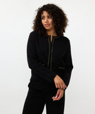 Woman wearing a black outfit with a white background