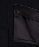 Close-up of a black jacket with a pocket