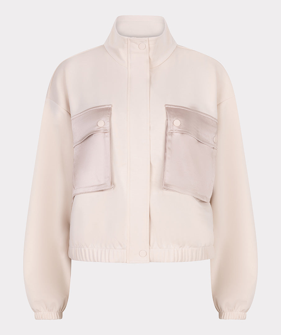 Beige jacket with front pockets on a light gray background