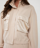 Beige jacket with pockets on a white background