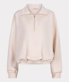 Beige sweatshirt with a zipper on a light gray background
