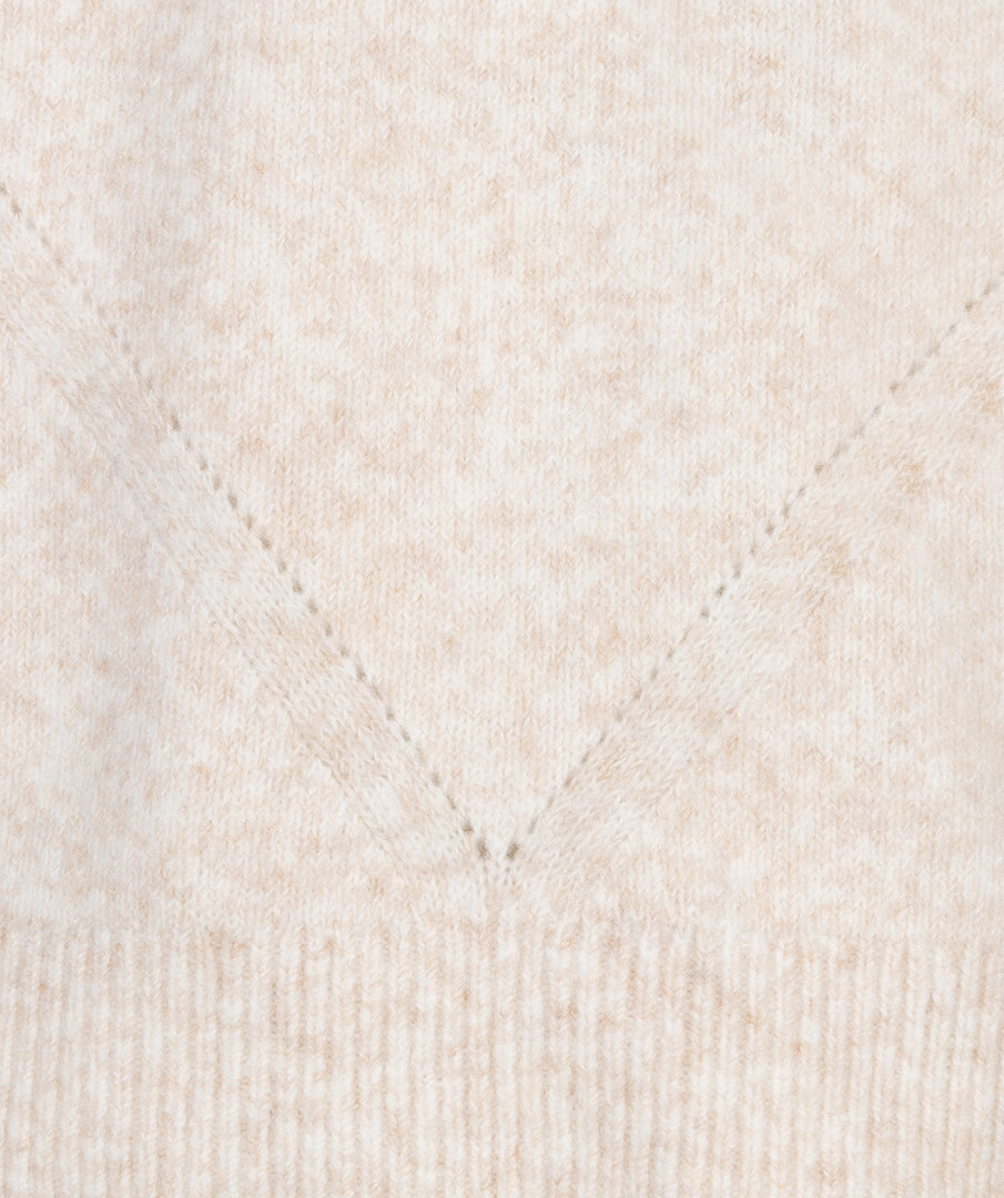 Close-up of a textured beige fabric with a diamond pattern