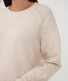 Close-up of a beige sweater on a white background