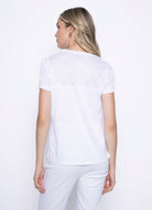 Woman wearing a white short sleeve top, viewed from the back.