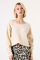 Closer view of the outfit showing the belt detail and the cozy fit of the sweater at the waist.